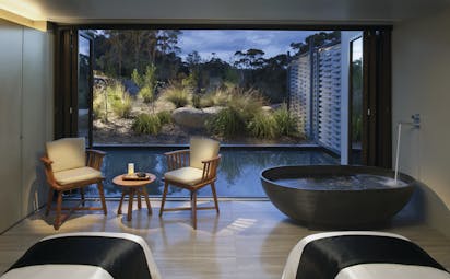 Saffire Freycinet Tasmania spa area with a freestanding bath and patio doors to outdoor pool