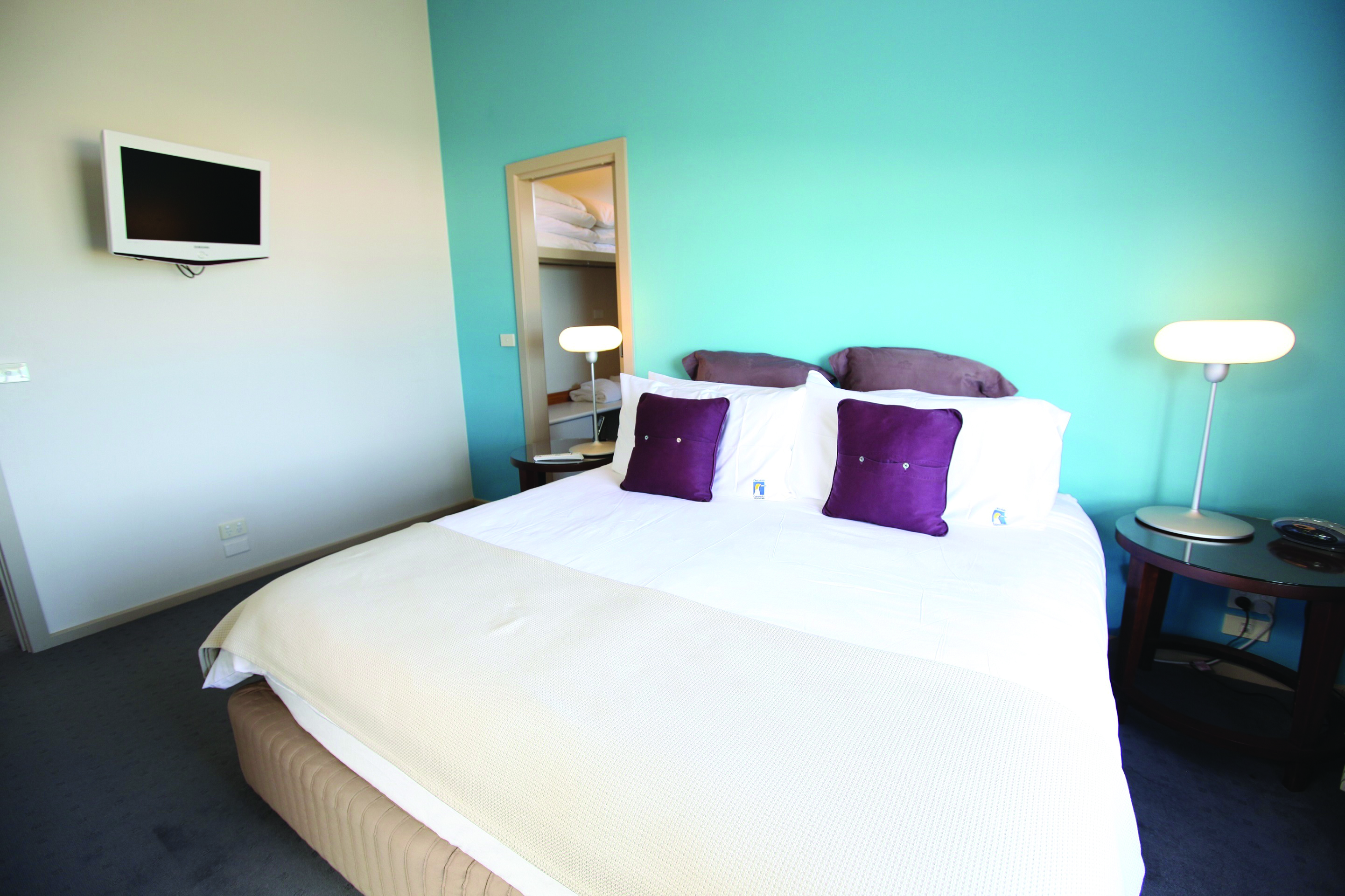 Chocolate Gannets Victoria and Melbourne bedroom with blue walls and television