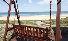 Chocolate Gannets Victoria and Melbourne exterior wooden love seat swing overlooking beach 
