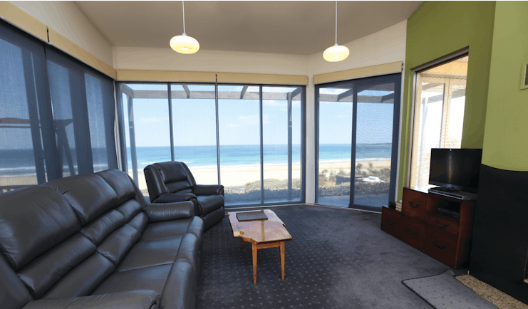 Chocolate Gannets Victoria and Melbourne lounge with large sofa floor to ceiling windows and beach view