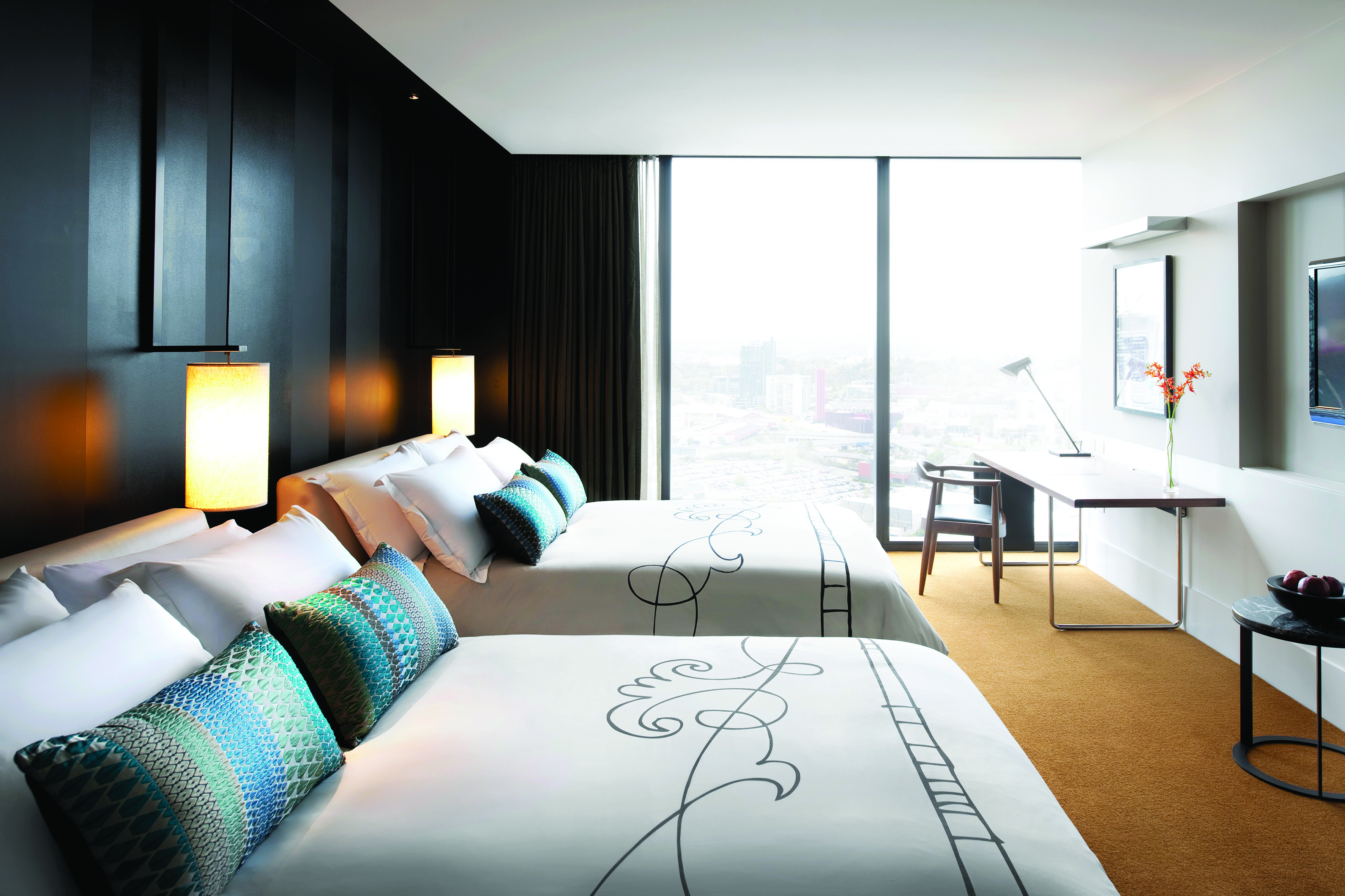 Luxury twin room with twin double beds, large windows and a desk