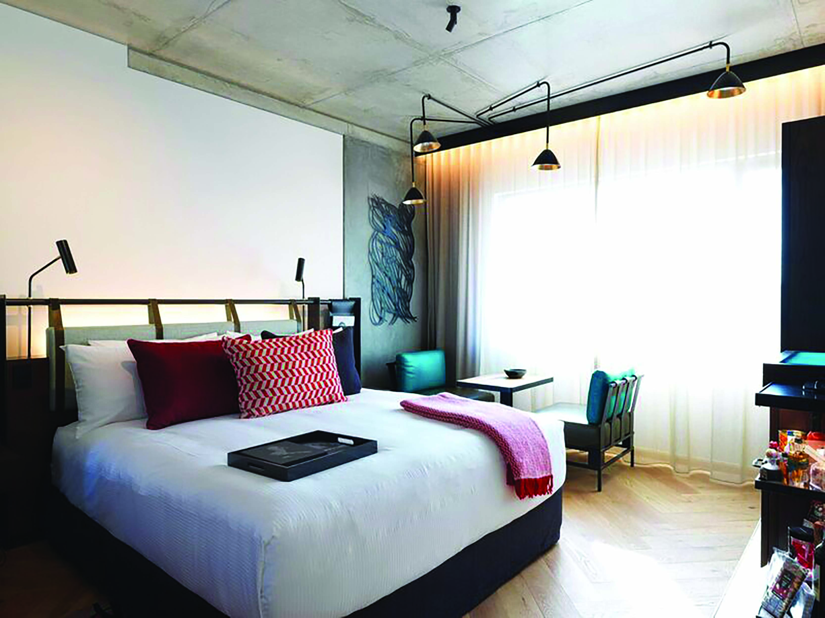 QT Melbourne Deluxe guestroom kingsize bed, modern decor