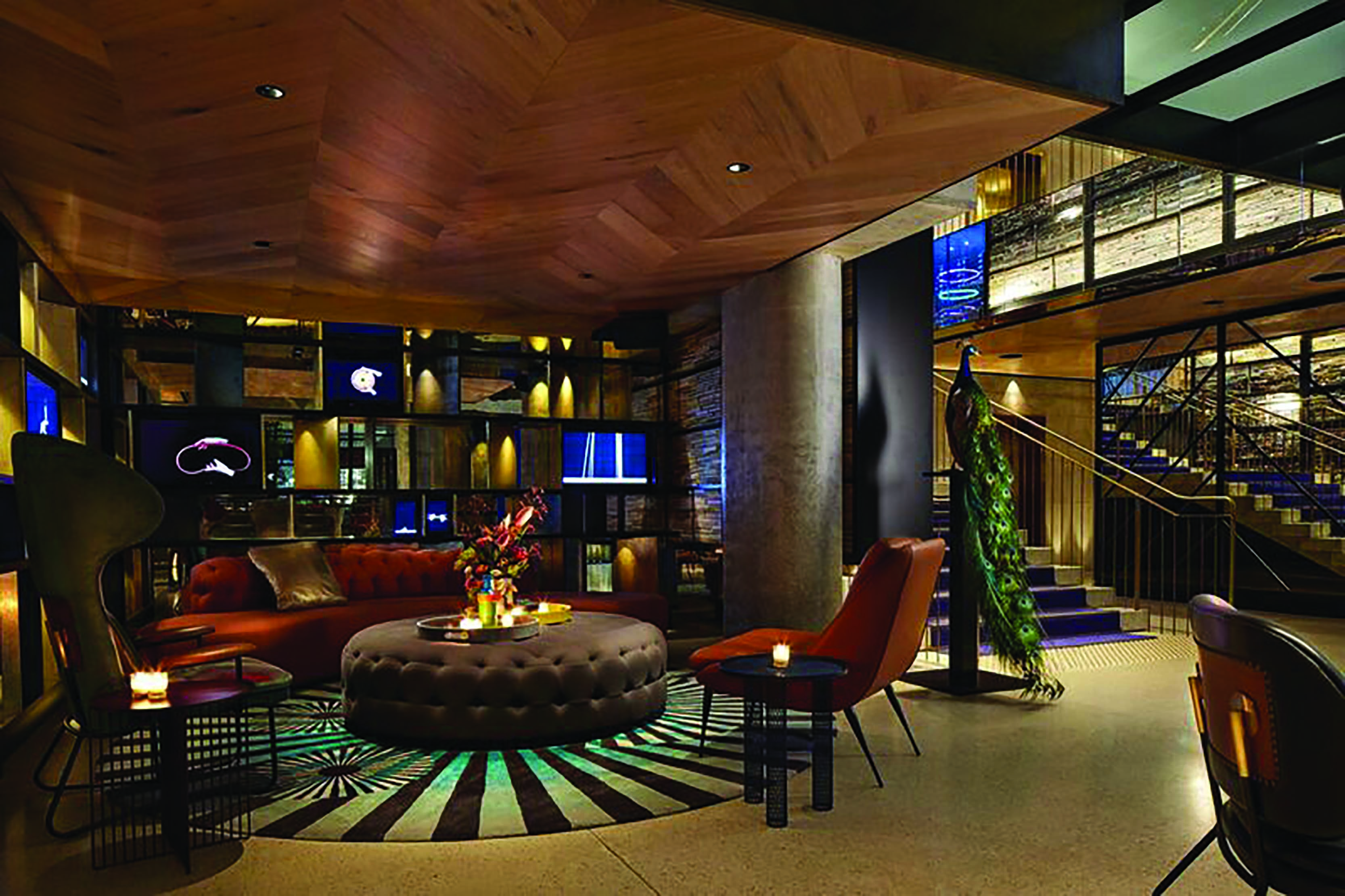 QT Melbourne lobby, chairs and sofa, dark and artistic decor, peacock