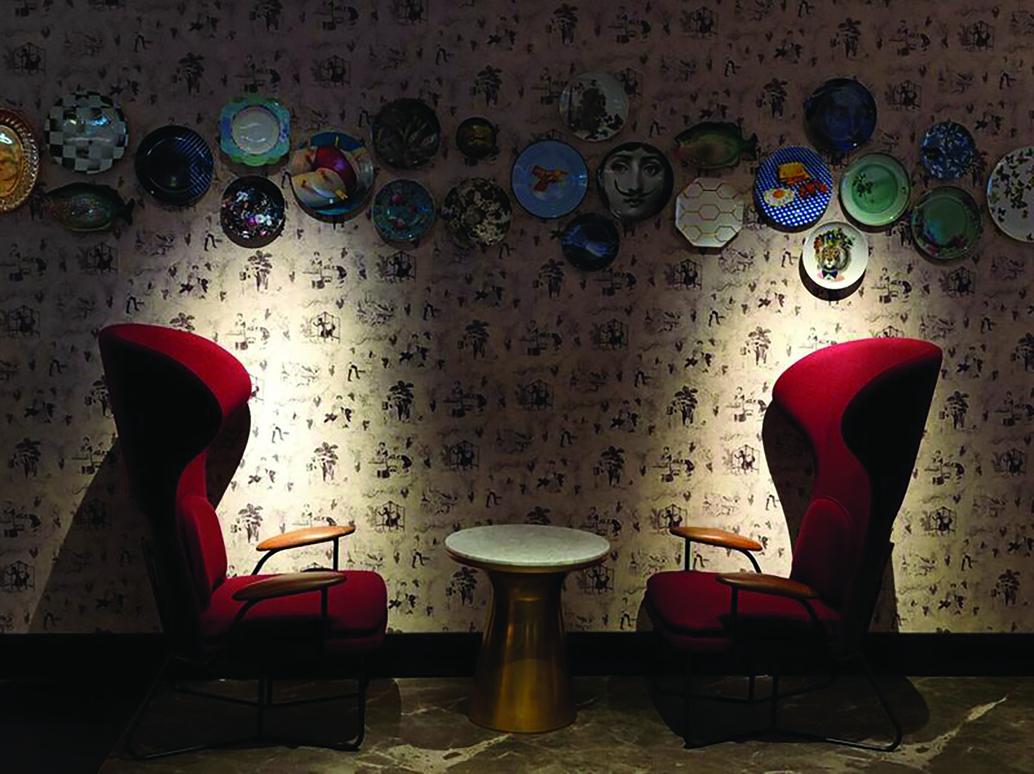 QT Melbourne Pascale bar, highbarked armchairs in red velvet, plates decorating wall