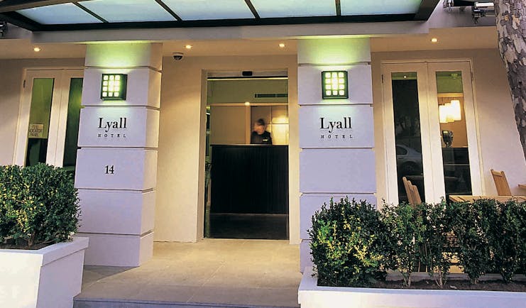 The Lyall Hotel Melbourne exterior white building entrance with signs reading 'The Lyall Hotel'
