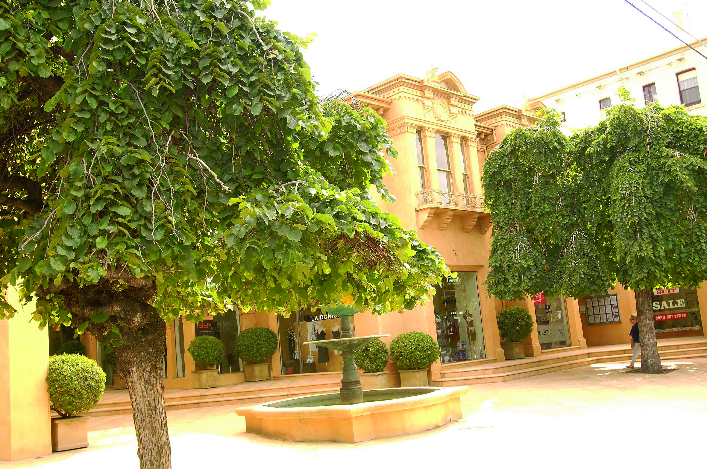 The Lyall Hotel Melbourne South Yarra exterior view of yellow building with arches and trees