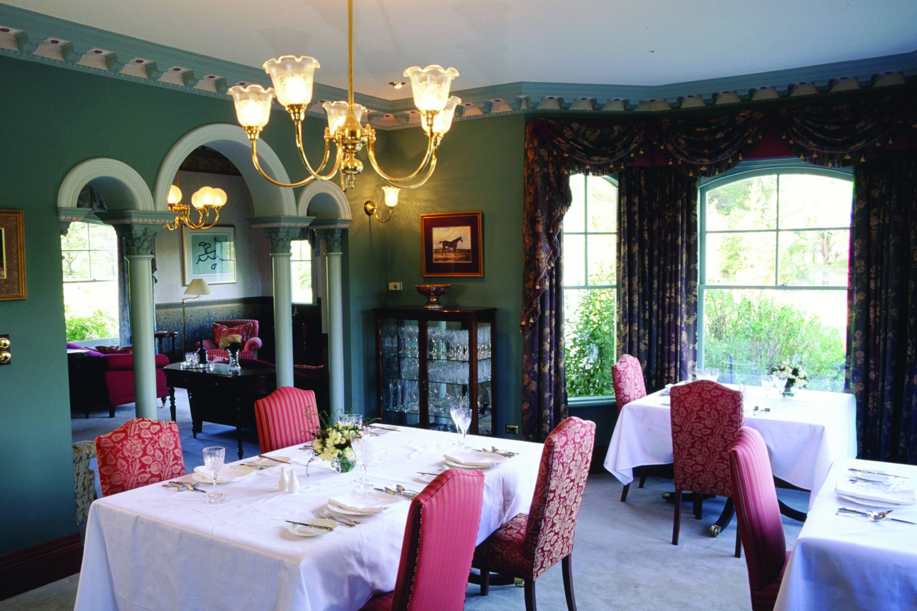 Woodman Estate Victoria formal dining room with arches chandeliers and draped curtains