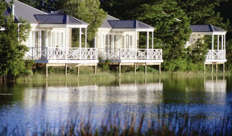 Woodman Estate Victoria lakeside chalets three white wooden chalets with balconies overlooking a lake