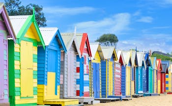 Multi coloured beach huts in a row on Brighton Beach Melbourne