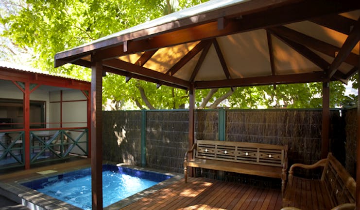 Cable Beach Club villa exterior, enclosed private terrace with plunge pool, wooden benches under wooden canopy
