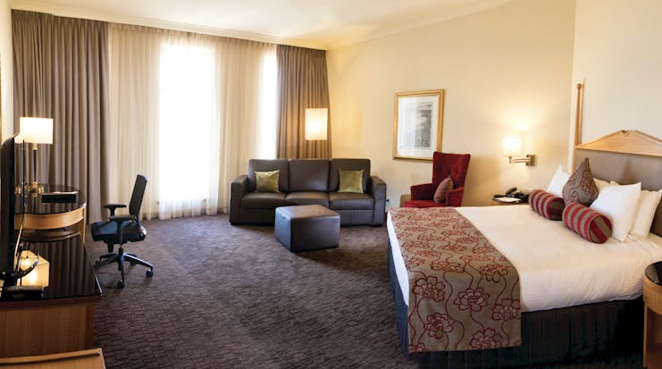Duxton Hotel Western Australia and Perth club king bedroom with sofa and desk