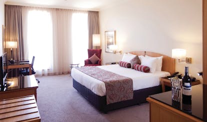 Duxton Hotel Western Australia and Perth deluxe king bedroom with desk and television