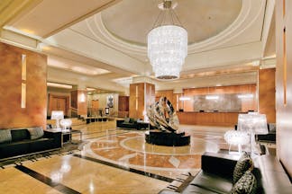 Duxton Hotel Western Australia and Perth lobby area with glass chandelier marble floor and metal sculpture