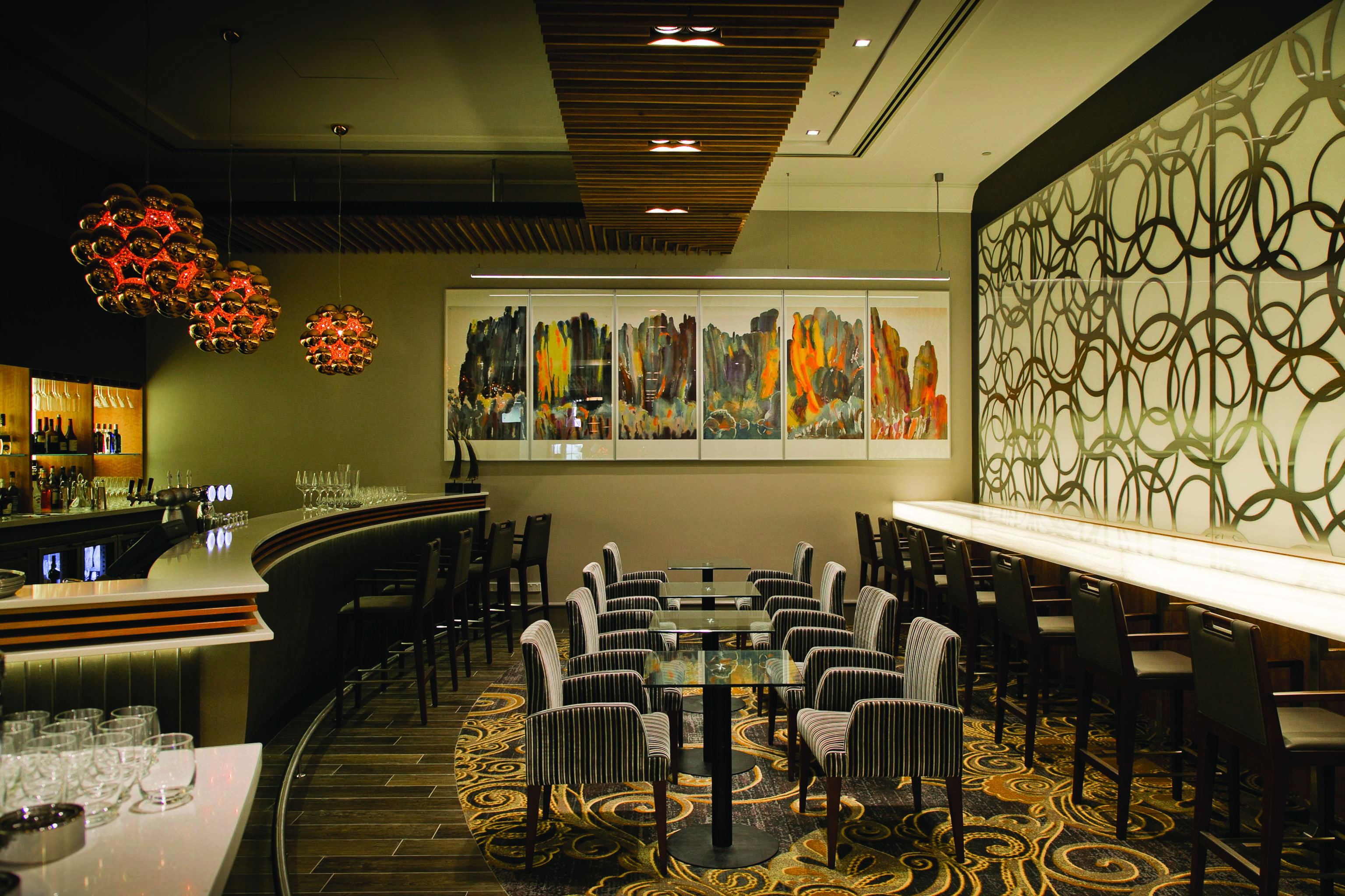 Duxton Hotel Western Australia and Perth restaurant cocktails bar area with graphic wallpaper and art