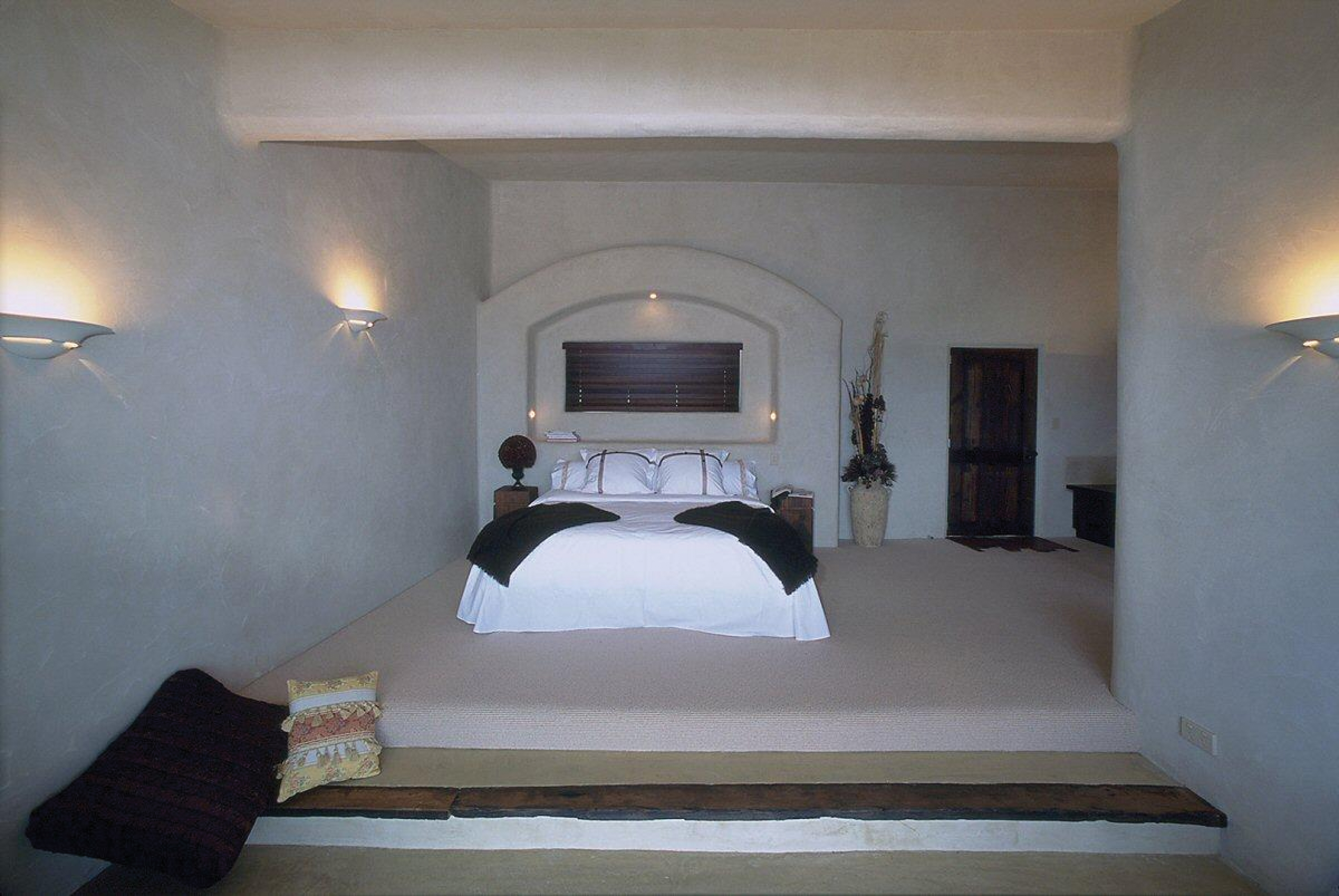 Bedroom with double bed, lights on the walls and television