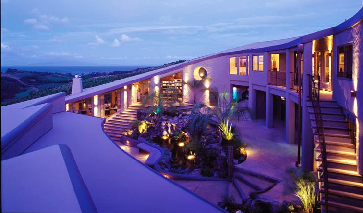 Delamore Lodge Waiheke Island Auckland exterior white building with round window and several outdoor staircases