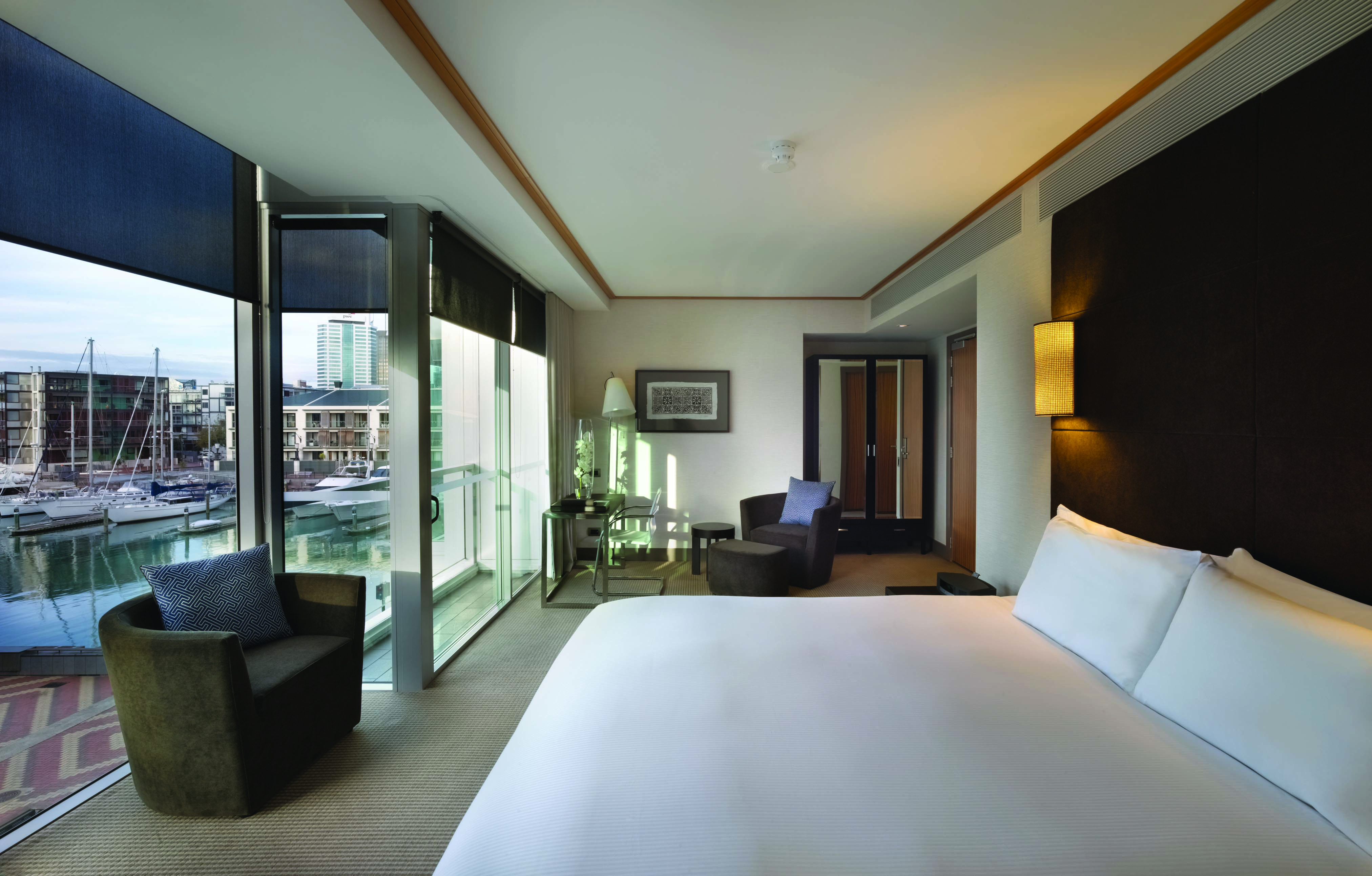 Sofitel Viaduct Auckland Harbour marina room bedroom with floor to ceiling windows and marina view