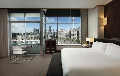 Sofitel Viaduct Auckland Harbour prestige room bedroom with large windows and city view