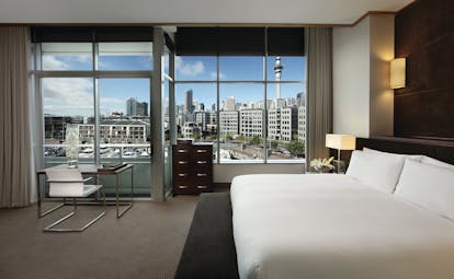 Sofitel Viaduct Auckland Harbour prestige room bedroom with large windows and city view
