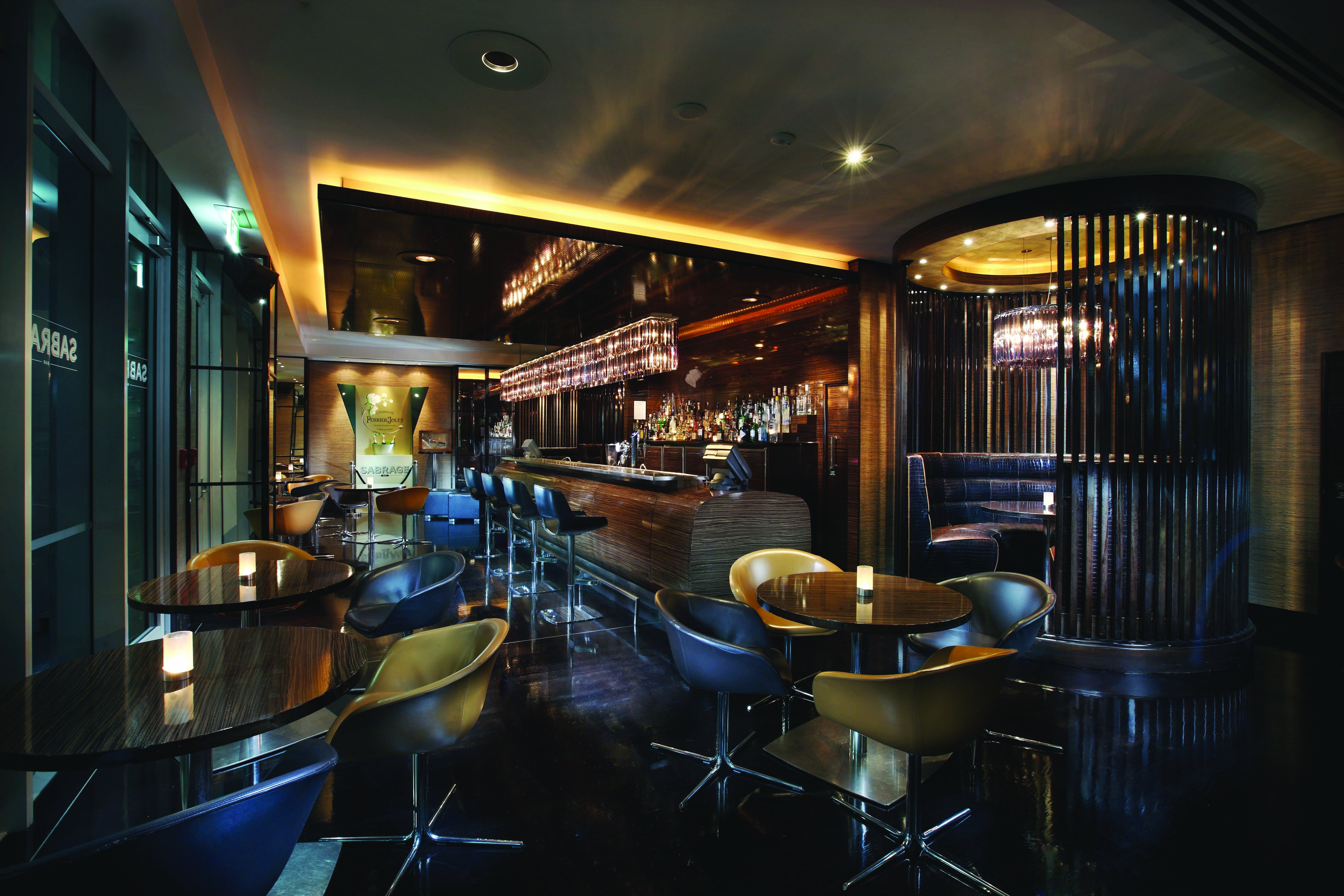 Sofitel Viaduct Auckland Harbour Sabrage bar area with tables and chairs and booths