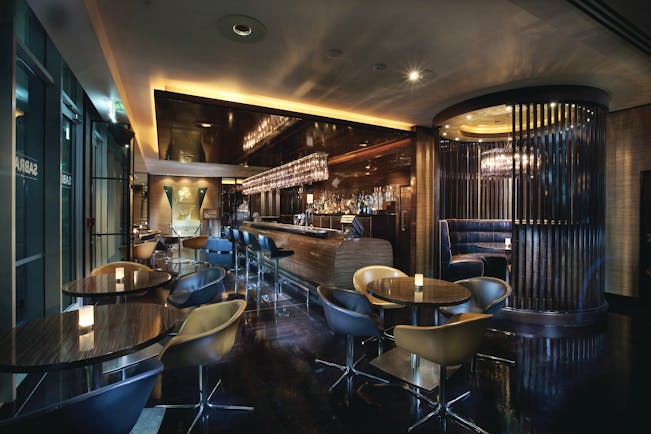 Sofitel Viaduct Auckland Harbour Sabrage bar area with tables and chairs and booths