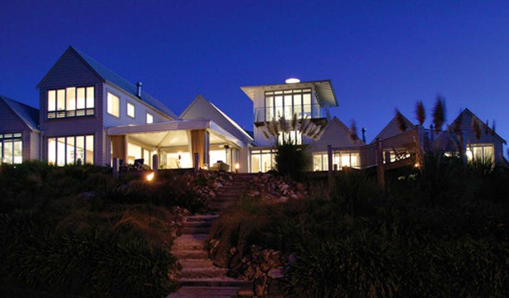 The Boatshed Waiheke Island Auckland exterior night white building with large windows at night