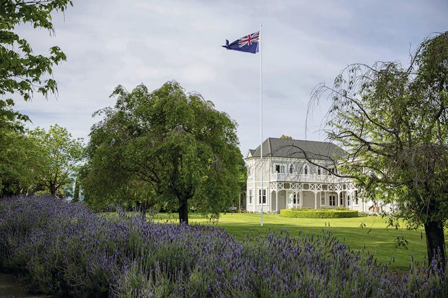 Marlborough Lodge Blenheim and Marlborough exterior white building with covered porch trees and lavender bushes