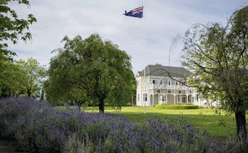 Marlborough Lodge Blenheim and Marlborough exterior white building with covered porch trees and lavender bushes