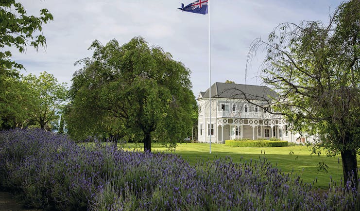 Marlborough Lodge Blenheim and Marlborough exterior white building with covered porch trees and lavender bushes