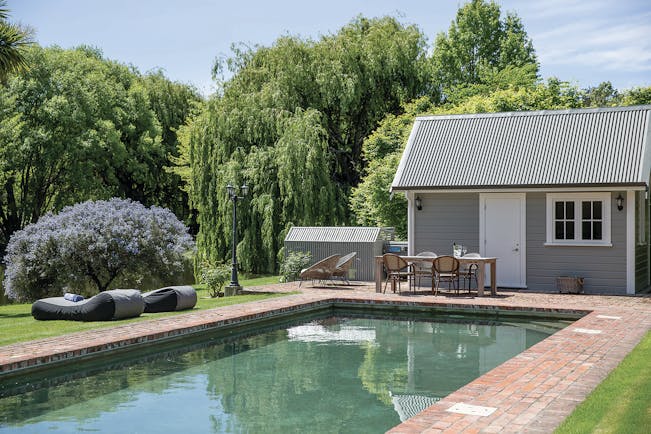 Marlborough Lodge Blenheim and Marlborough pool in garden with trees and lavender