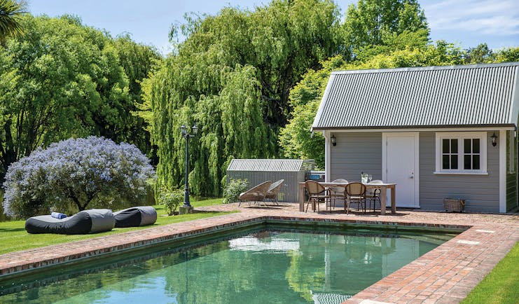 Marlborough Lodge Blenheim and Marlborough pool in garden with trees and lavender