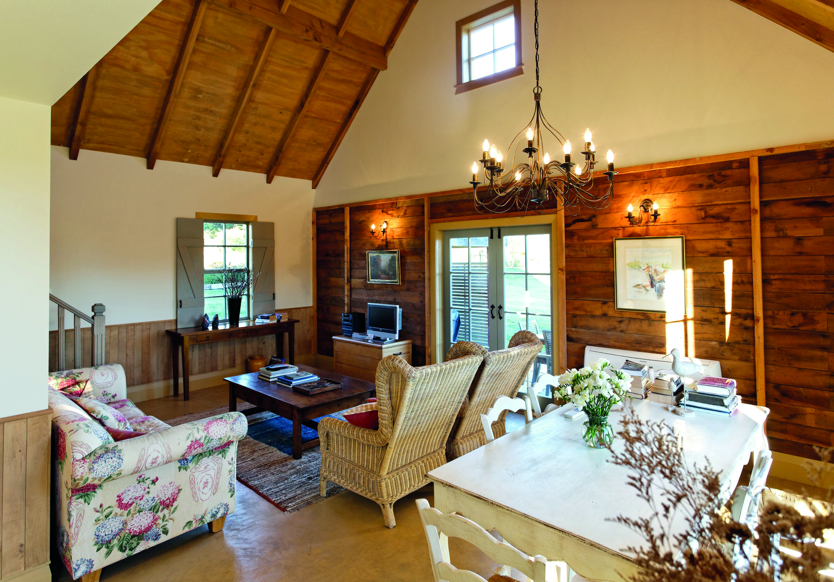 The Bell Tower on Dog Point Blenheim and Marlborough french interior living room with wooden walls and chandelier