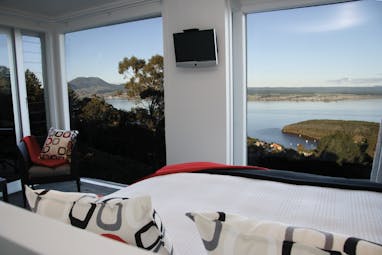 Acacia Cliffs Lodge Central North Island bedroom with large windows and coast view