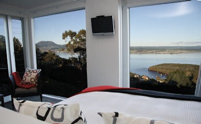 Acacia Cliffs Lodge Central North Island bedroom with large windows and coast view