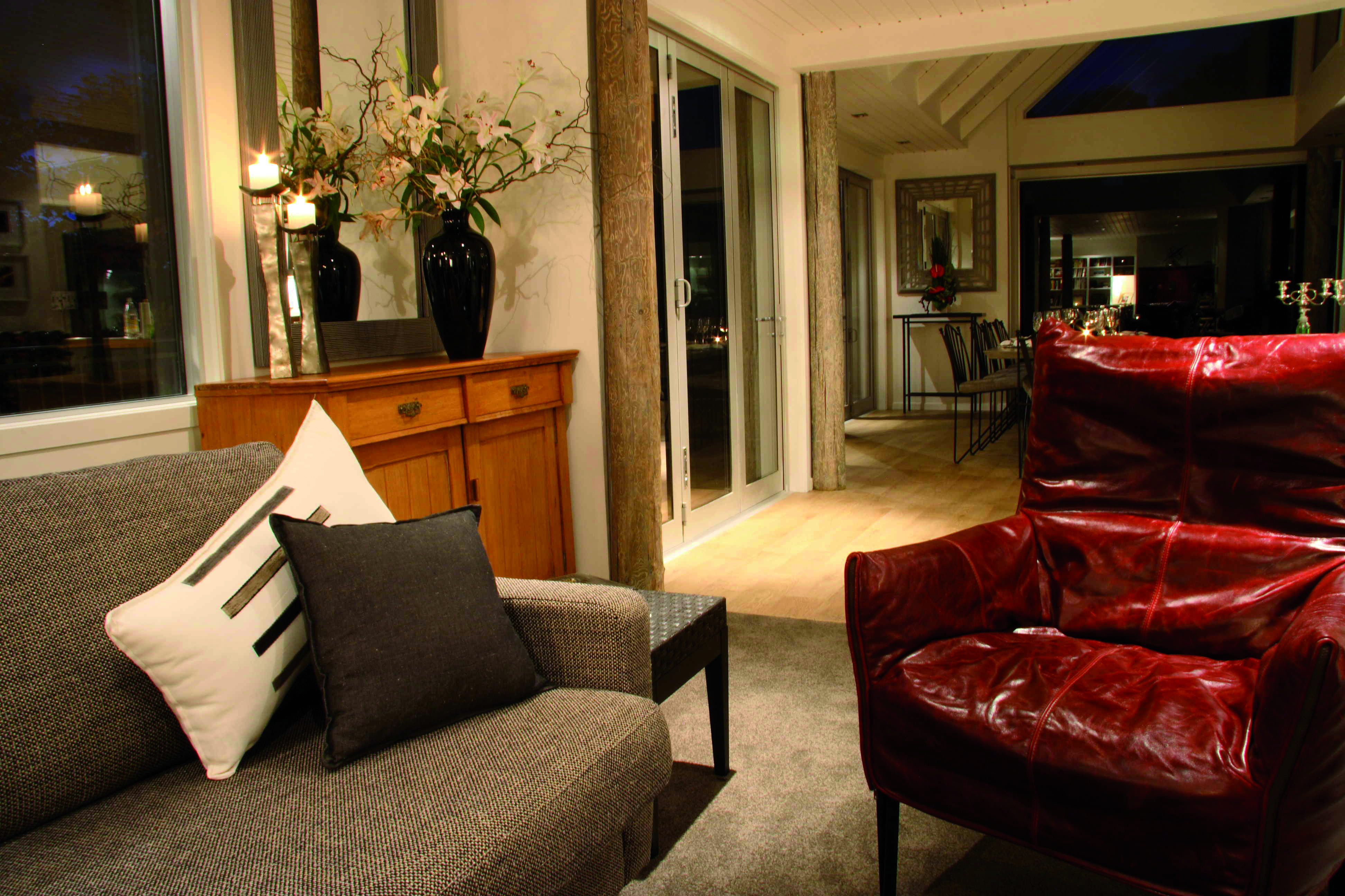 Acacia Cliffs Lodge Central North Island living room with sofa and leather armchair