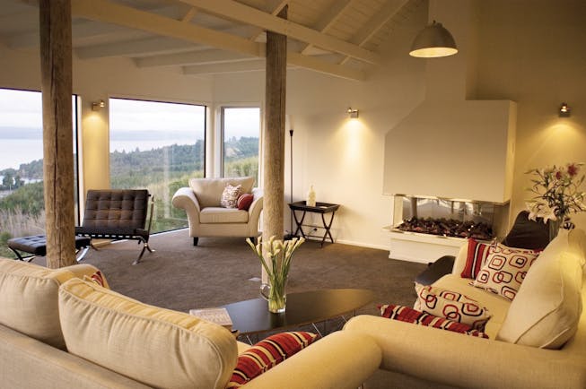 Acacia Cliffs Lodge Central North Island lounge with large windows and coast view