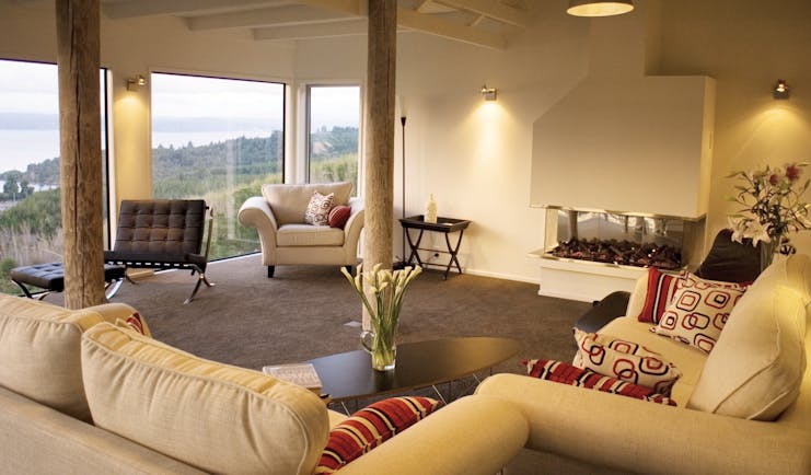 Acacia Cliffs Lodge Central North Island lounge with large windows and coast view