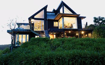 Acacia Cliffs Lodge Central North Island outside modern building with large lit up windows
