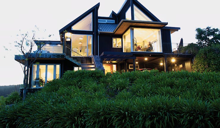 Acacia Cliffs Lodge Central North Island outside modern building with large lit up windows
