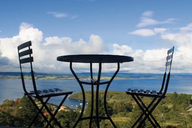 Acacia Cliffs Lodge Central North Island panorama table and two chairs overlooking the coast