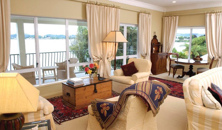 Black Swan Boutique Hotel Central North Island lounge area with armchairs and balcony with sea view
