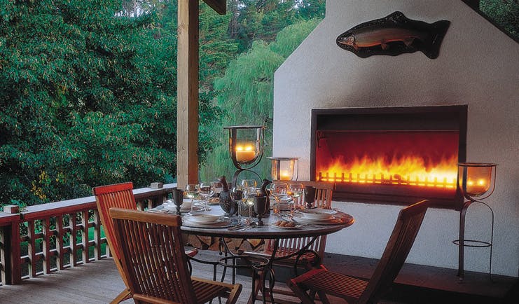 Huka Lodge Central North Island dining outdoor decked dining area with fireplace