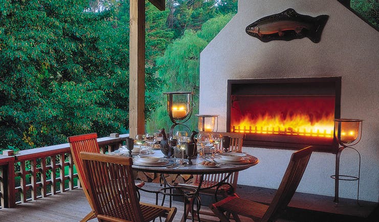 Huka Lodge Central North Island dining outdoor decked dining area with fireplace