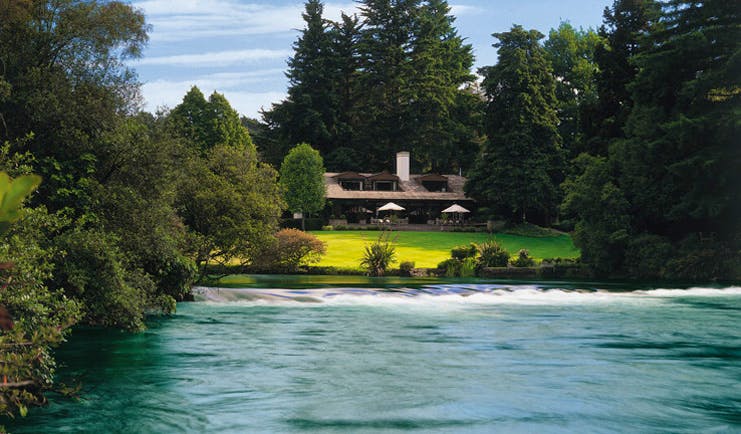 Huka Lodge Central North Island gardens view over river to lodge and gardens
