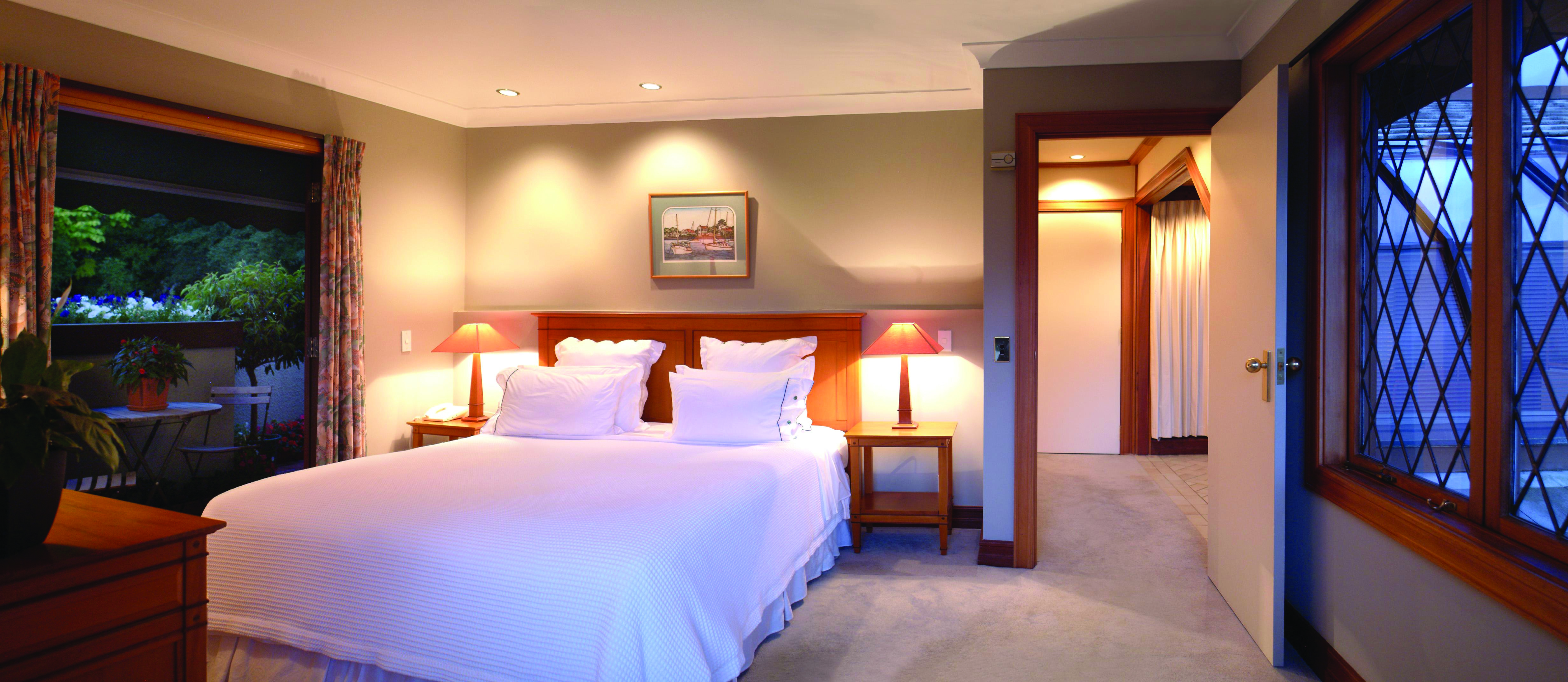 Suite with large double bed, lights, windows and balcony