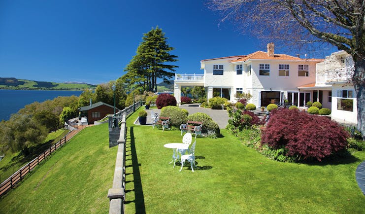 Peppers on the Point Central North Island garden white metal chairs and tables in garden overlooking lake