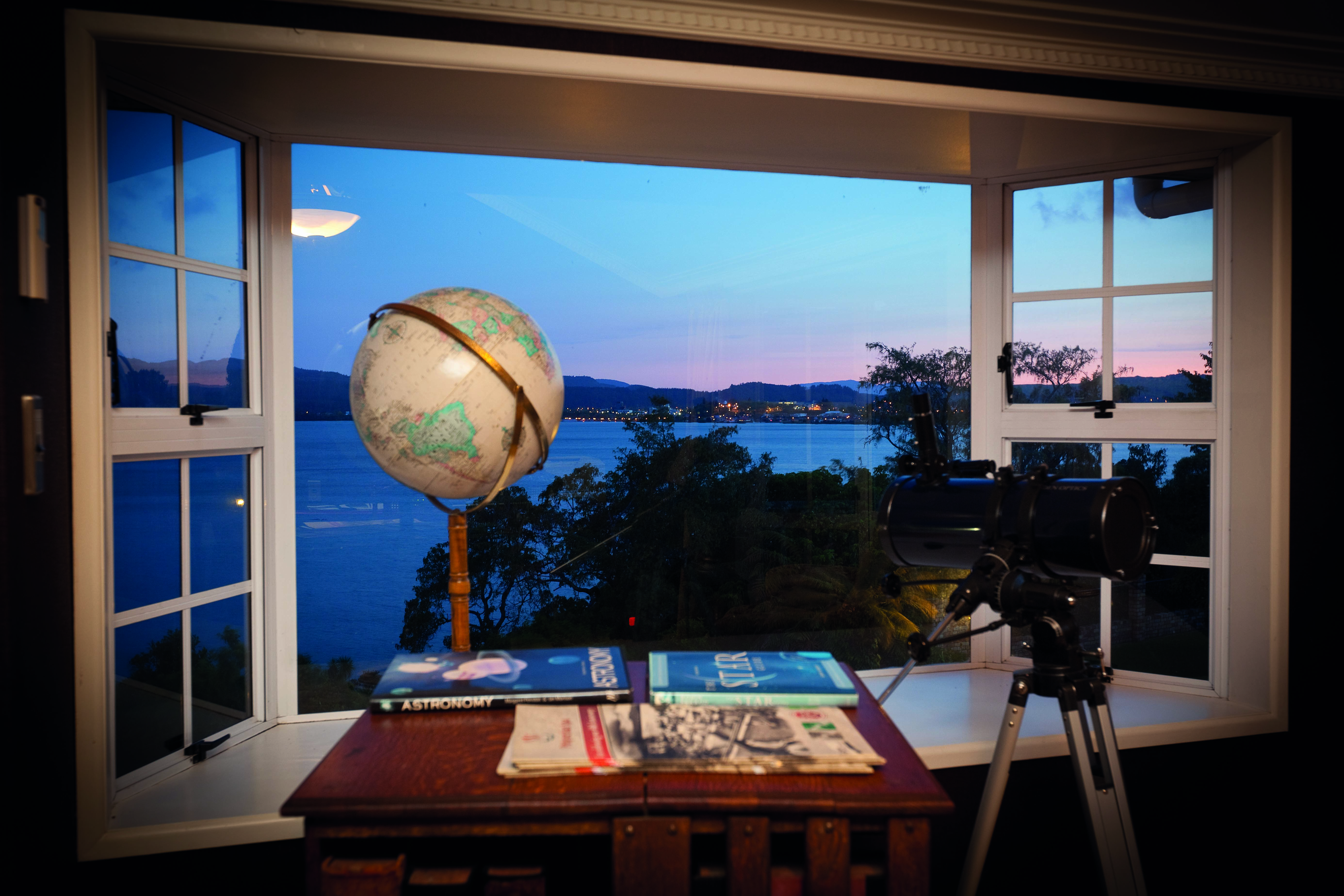 Peppers on the Point Central North Island viewpoint globe and telescope in a window with lake view