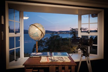 Peppers on the Point Central North Island viewpoint globe and telescope in a window with lake view