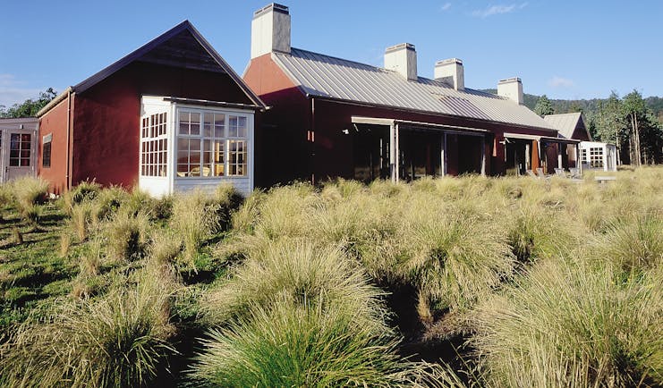Poronui Ranch Central North Island exterior red lodge building with wild grass