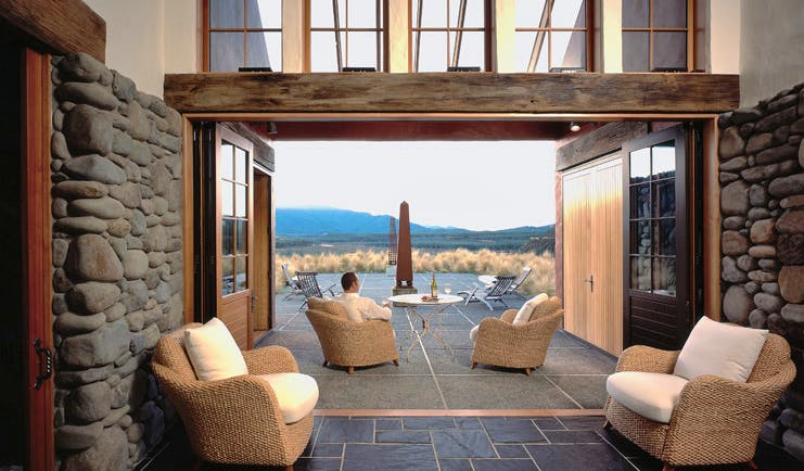 Poronui Ranch Central North Island lounge with stone walls and terrace